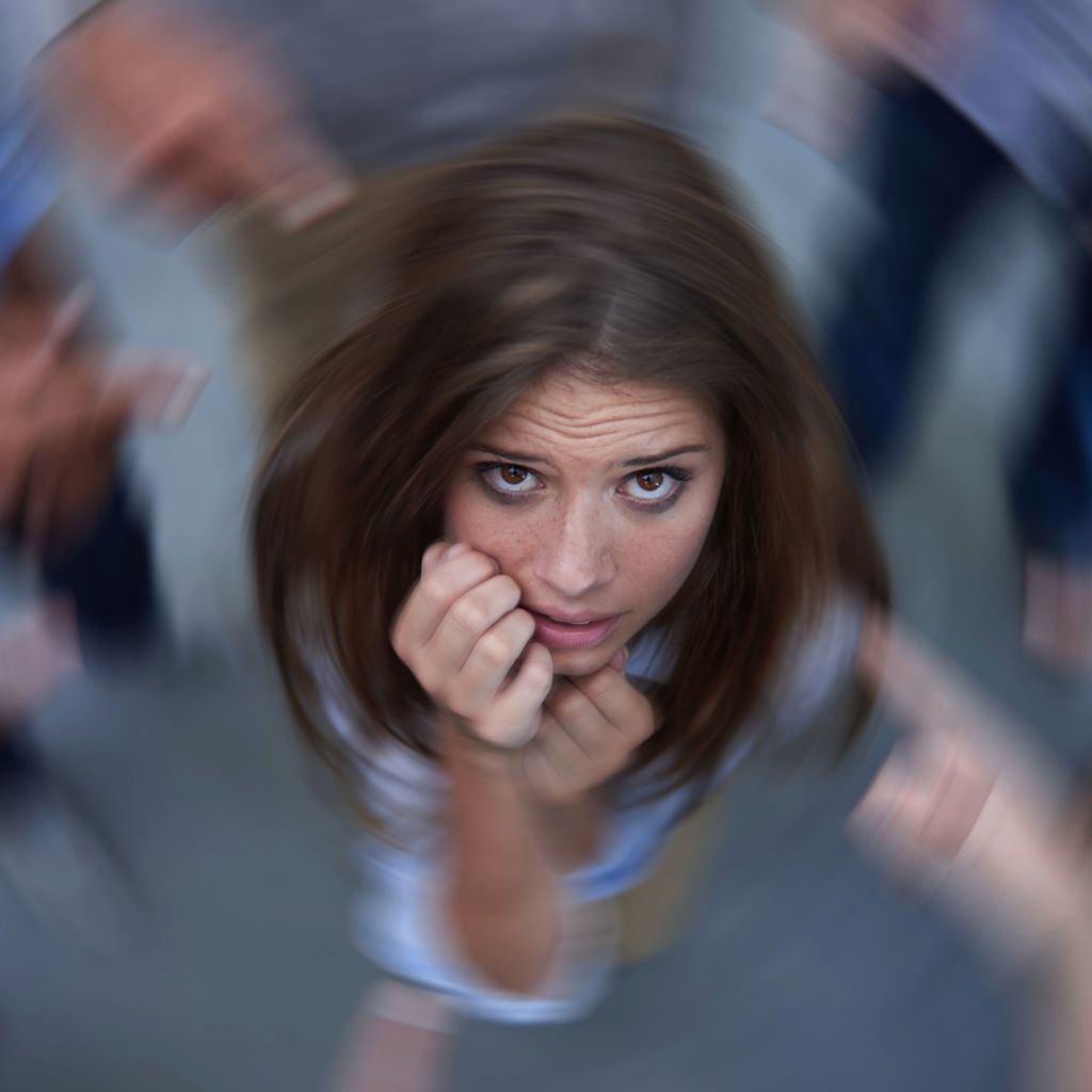 aerial view of an anxious woman in a crowd looking up